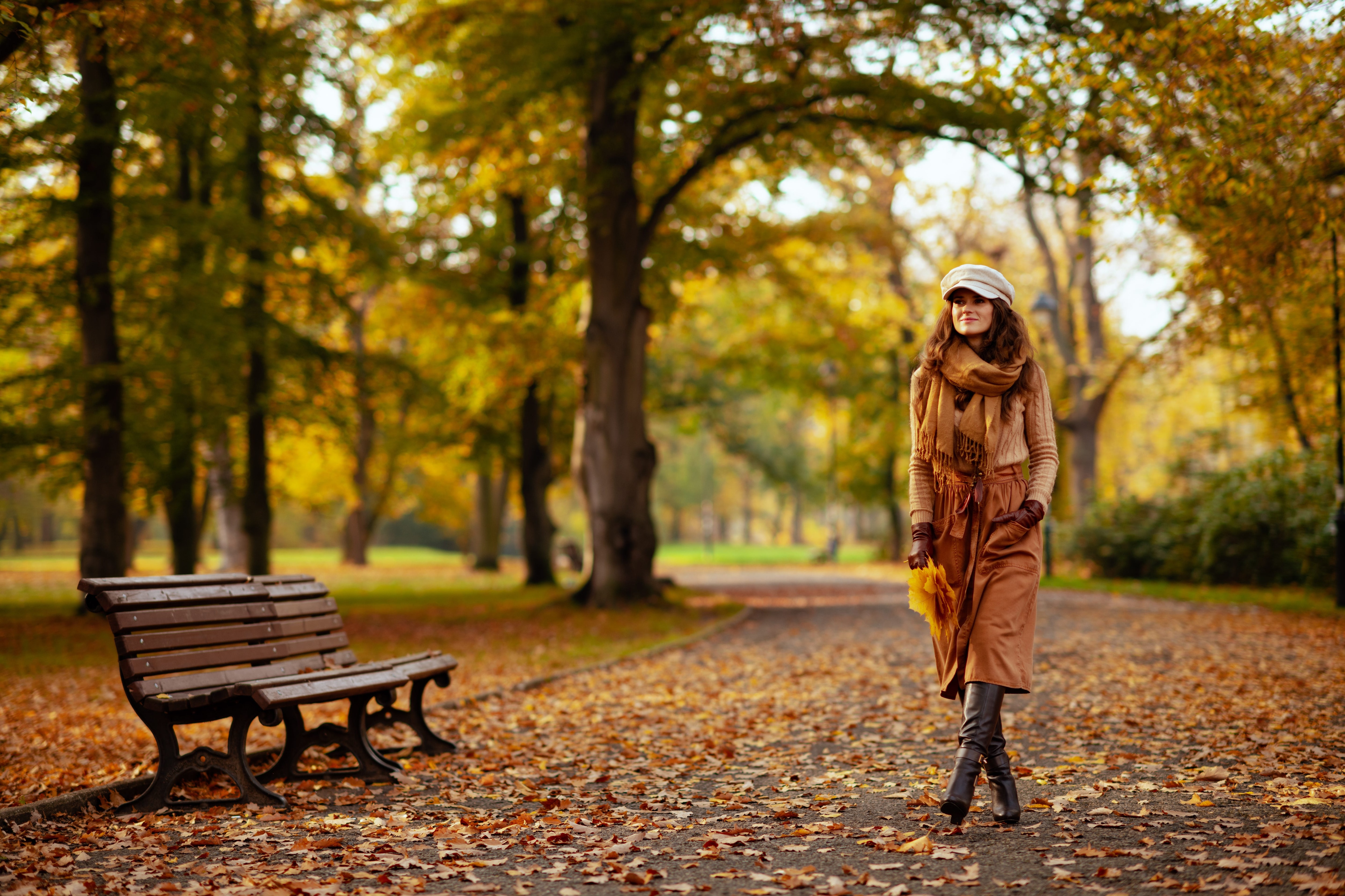 Woman walking through a park during autumn in a long dress.jpeg