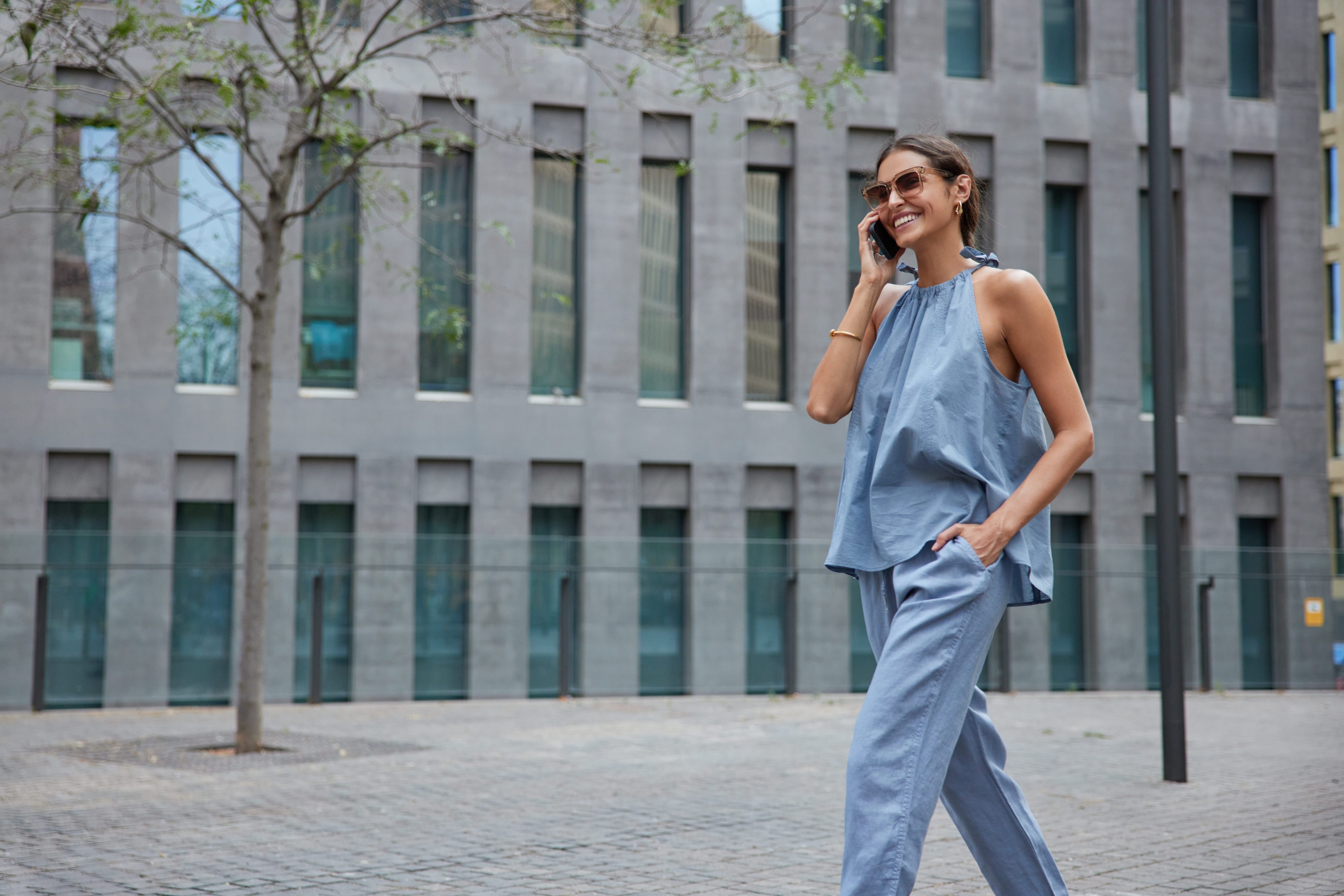 Stylish modern woman wearing stretch pants as she talks on the phone.jpeg