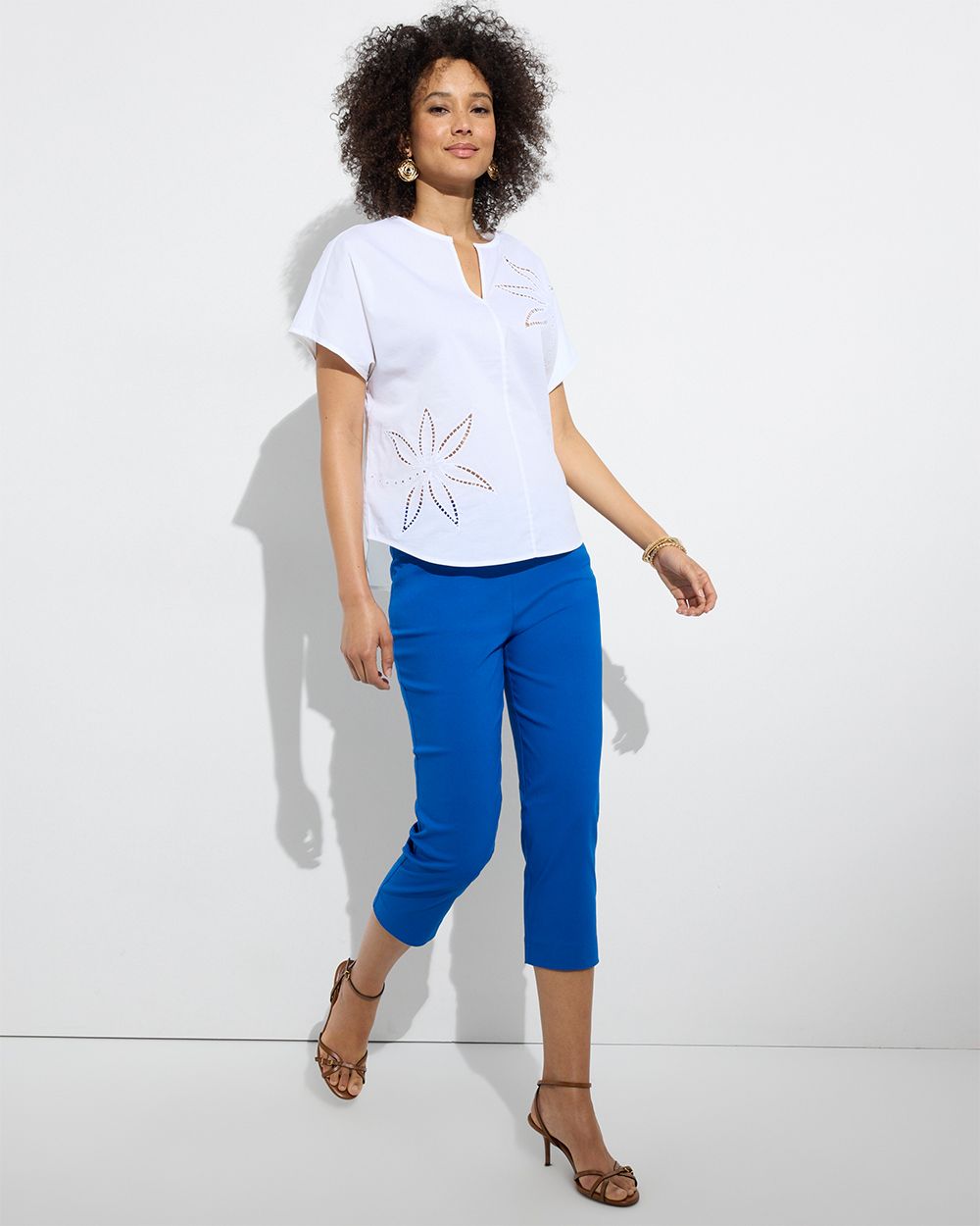 Chico's Outlet woman wearing white top with royal blue pants
