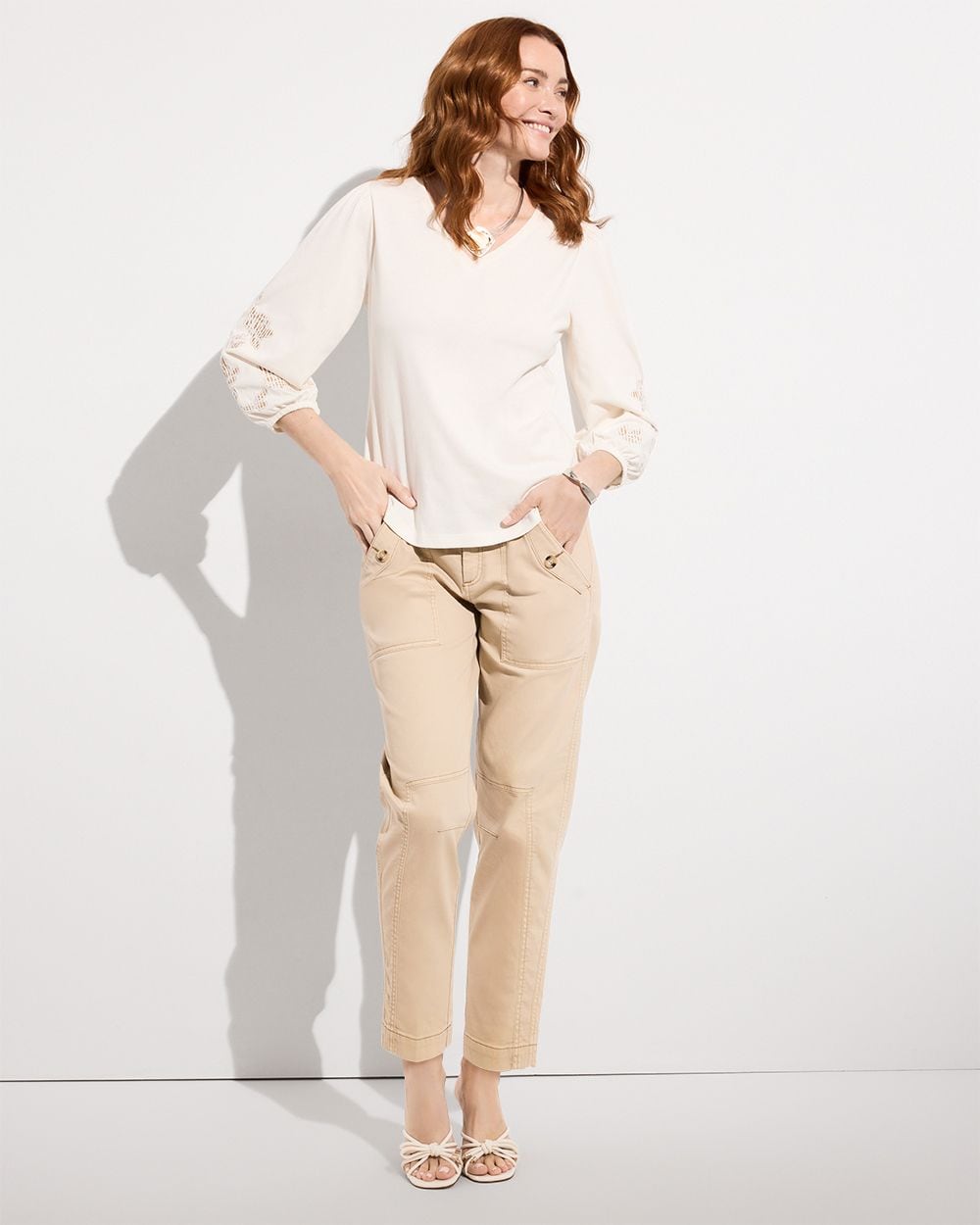 Woman wearing white top and tan cargo pants