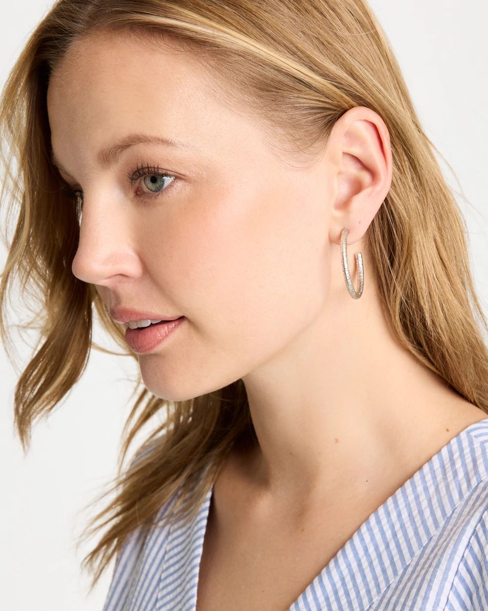 Silvertone Textured Hoop Earrings click to view larger image.